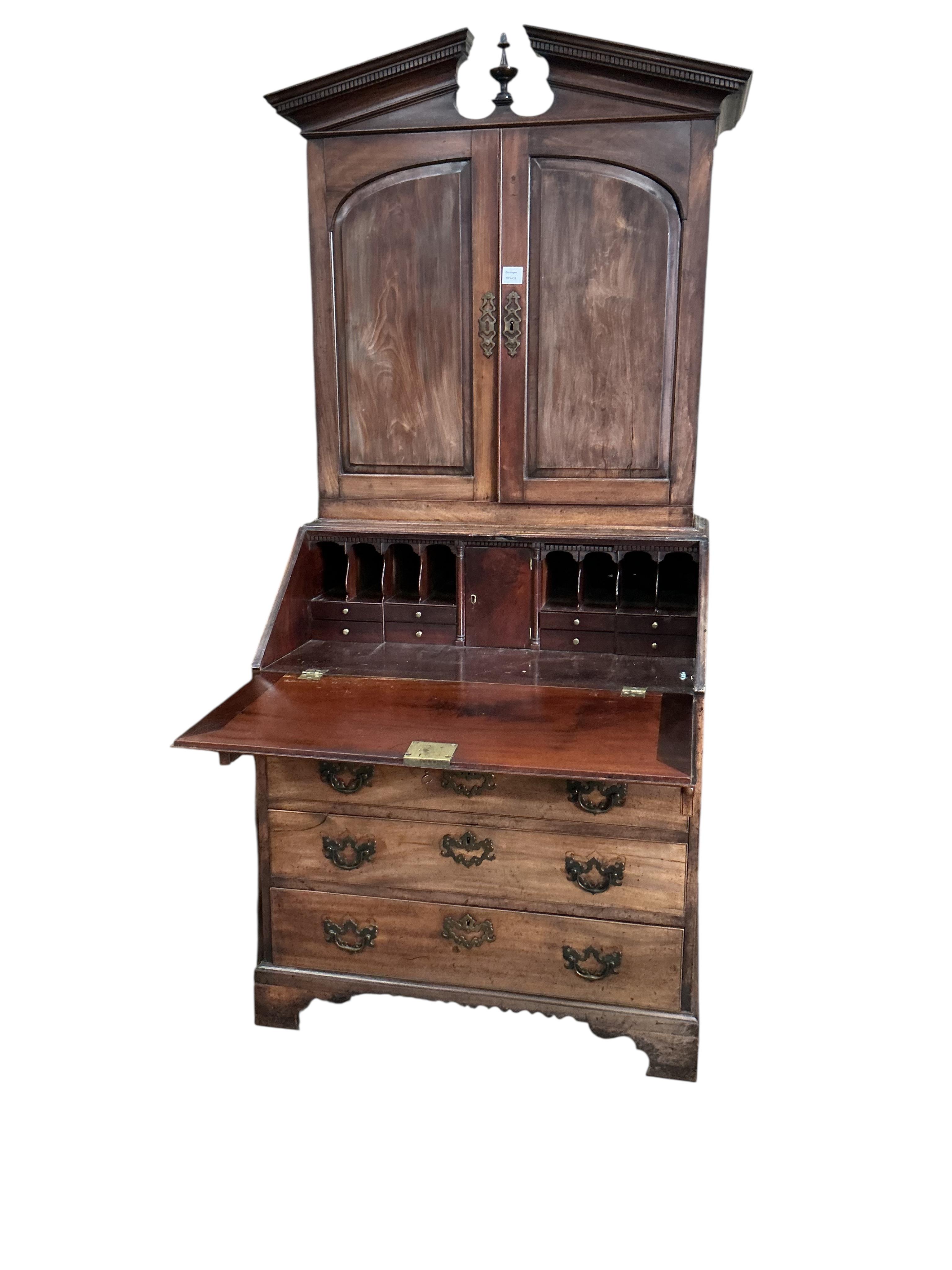 A small George III mahogany bureau cabinet with broken arch pediment, width 95cm, depth 62cm, height 198cm